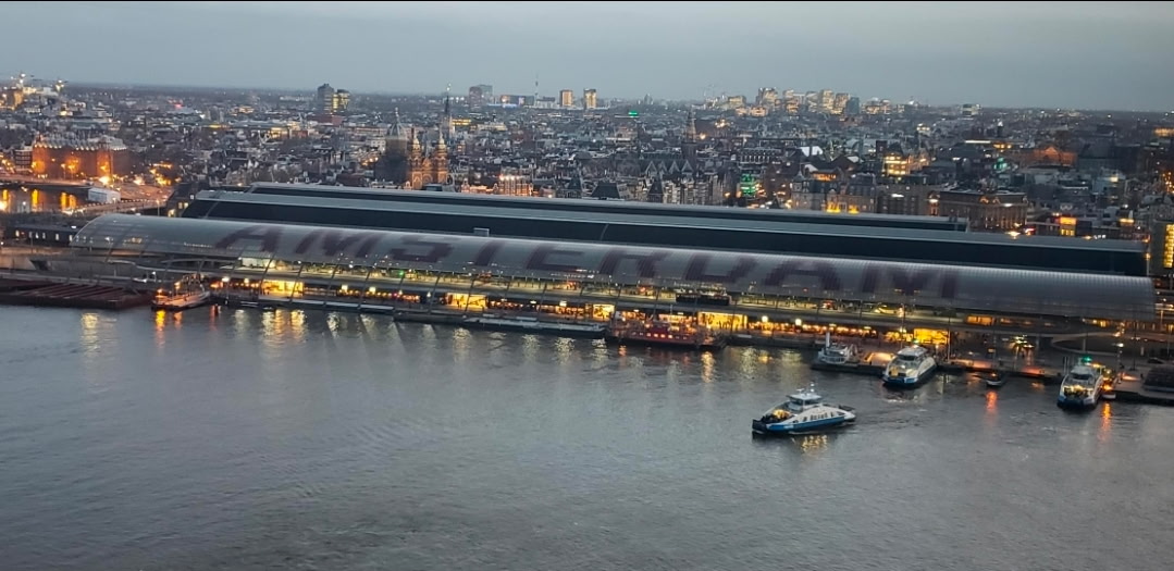 Amsterdam Centraal from across the IJ at dusk